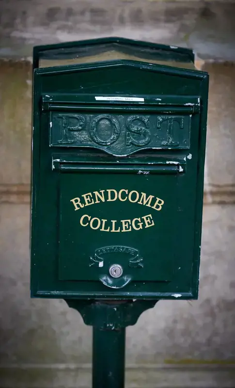 A green post box on Rendcomb College's grounds