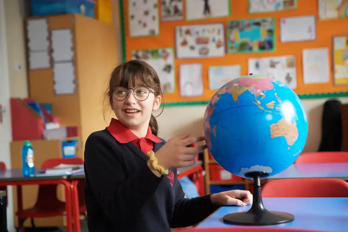 A student examining a globe