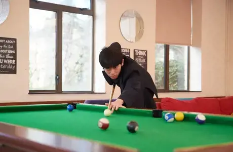 Rendcomb College student playing pool
