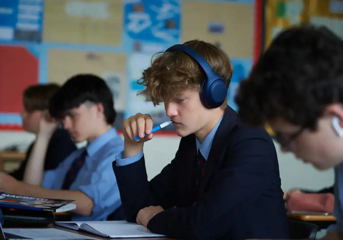 A senior school boy concentrating in class
