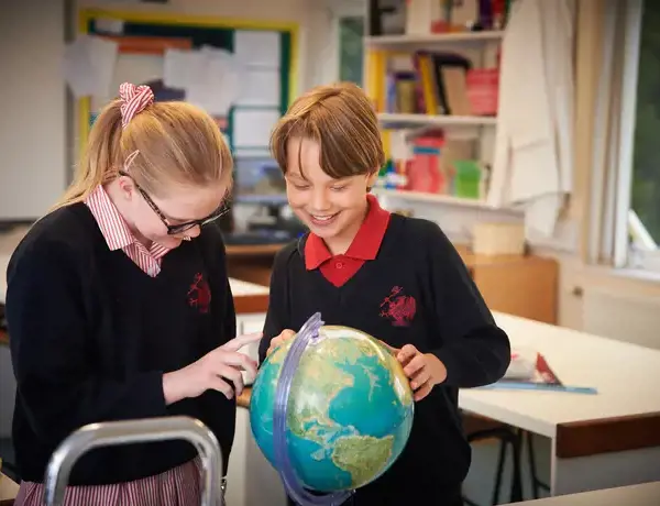 Junior School pupils with a globe of the world