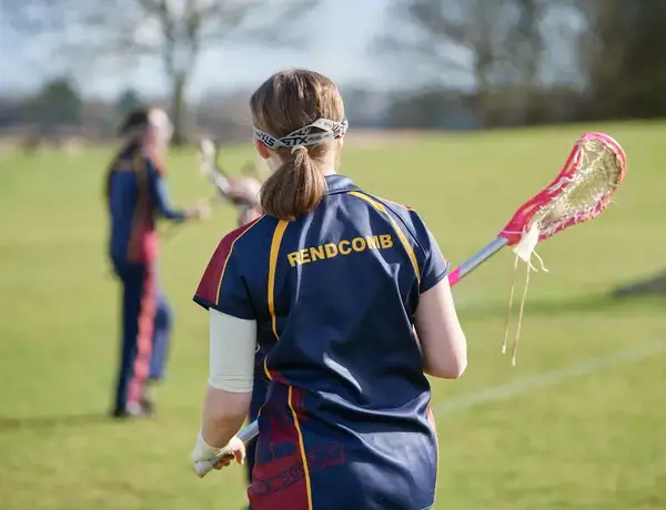 Rendcomb College pupil playing lacrosse