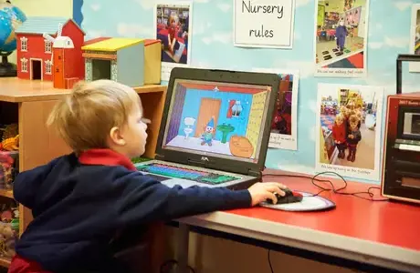 Young pupil working on the computer