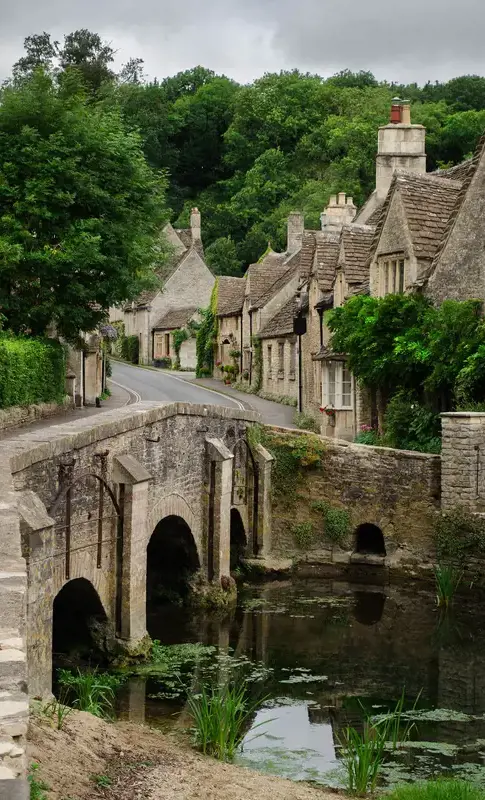 Castle Coombe bridge over river in the cotswolds.