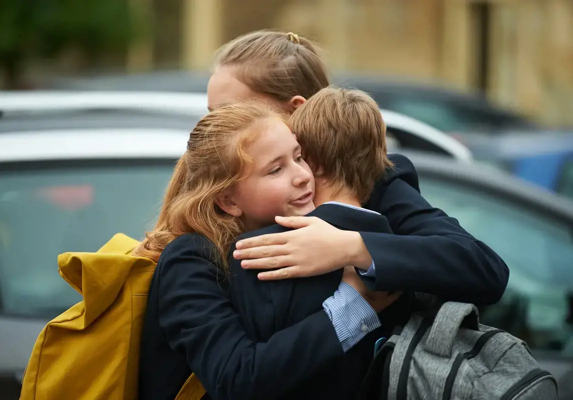 Two pupils hugging