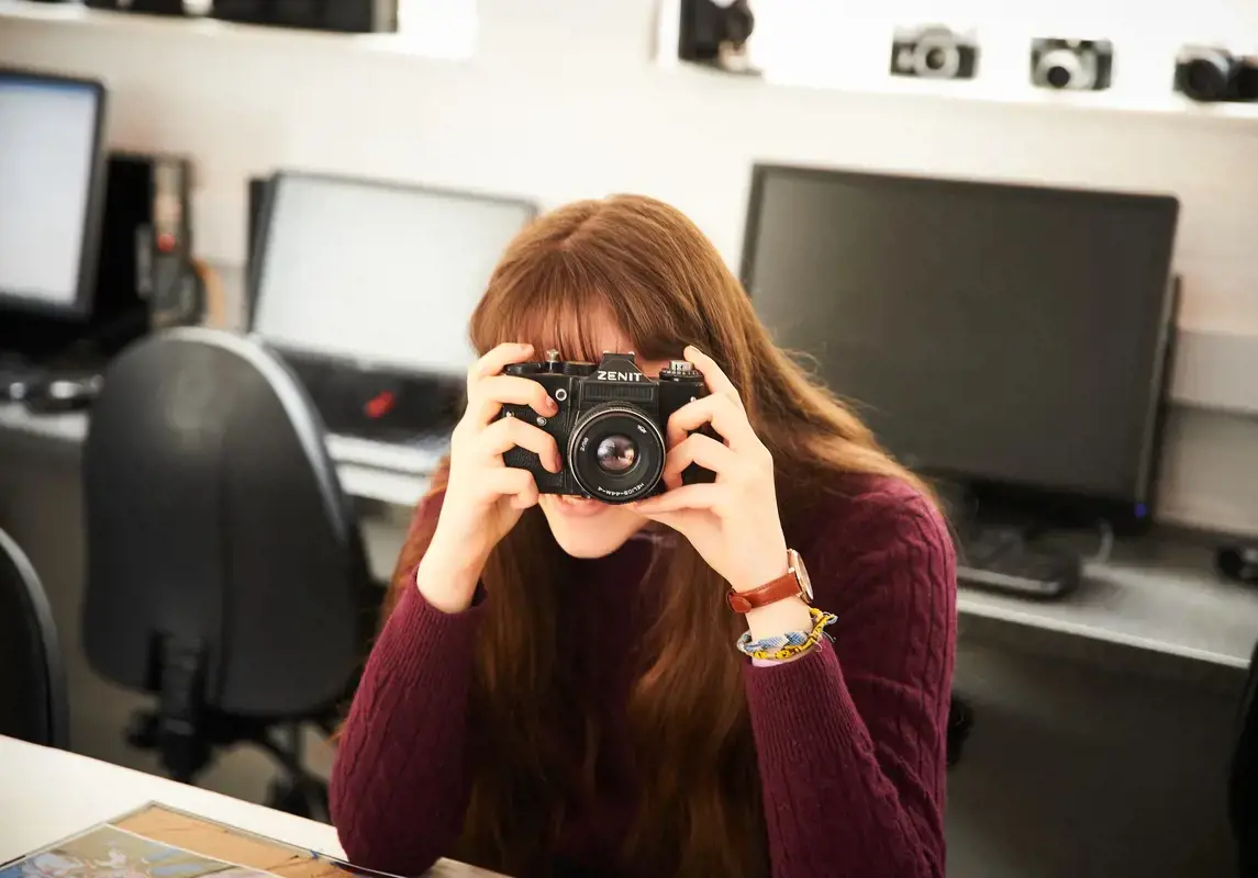 Girl holding an analogue camera