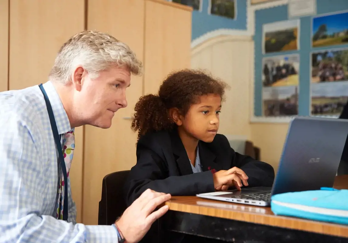 Rendcomb College teacher working with young student