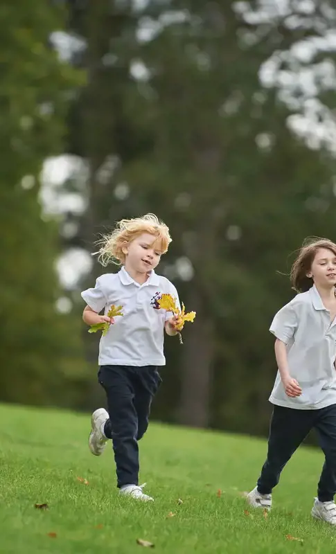 Nursery children running outdoors