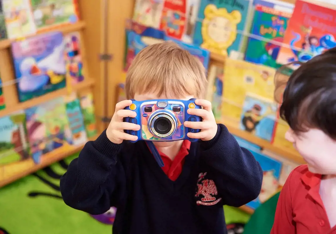 Child having fun with a camera