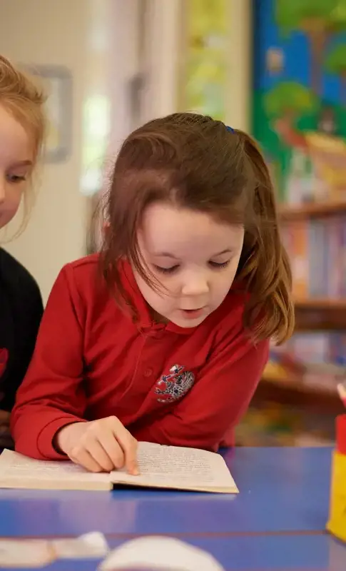 Nursery children in a bright classroom