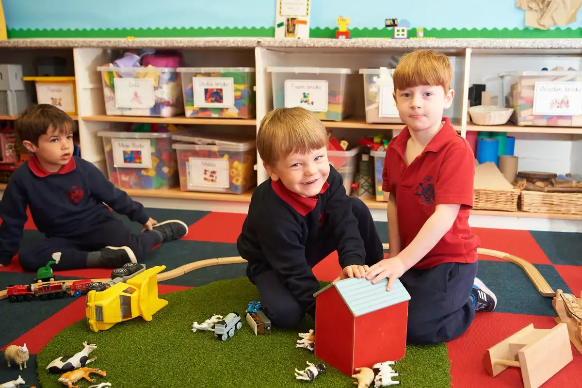 Nursery children playing with a farm set