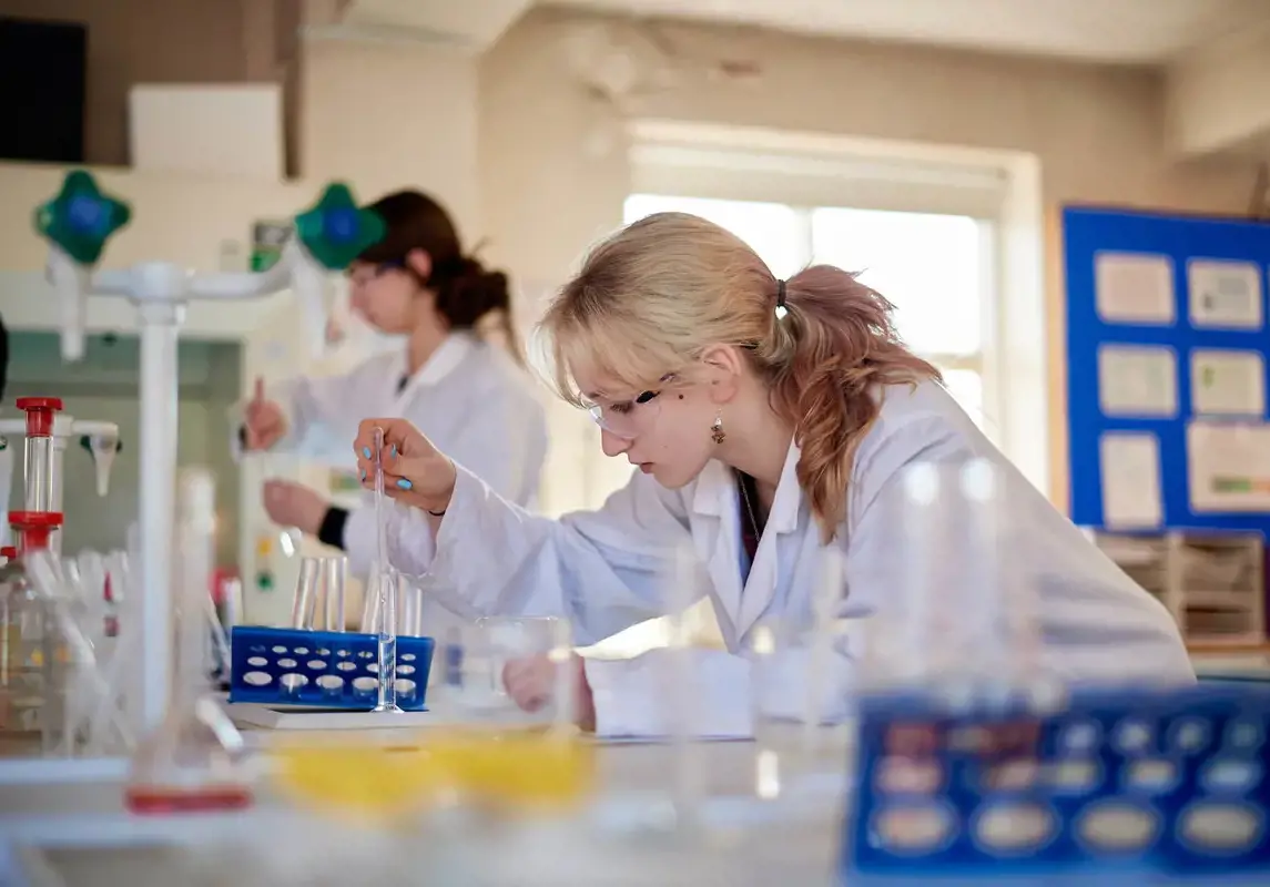 Rendcomb College Sixth Former in science class