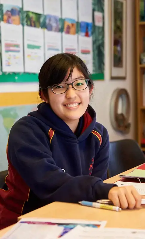 A happy Rendcomb College pupil in class