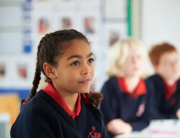 A happy and engaged Rendcomb College Junior school pupil