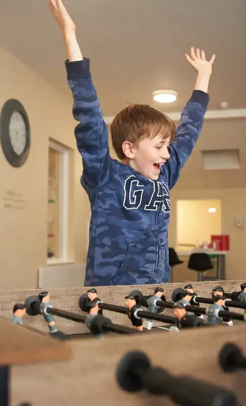 Boarding student enjoying a game of table football