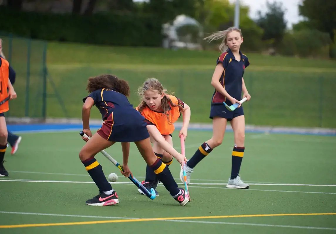 Rendcomb College students playing hockey