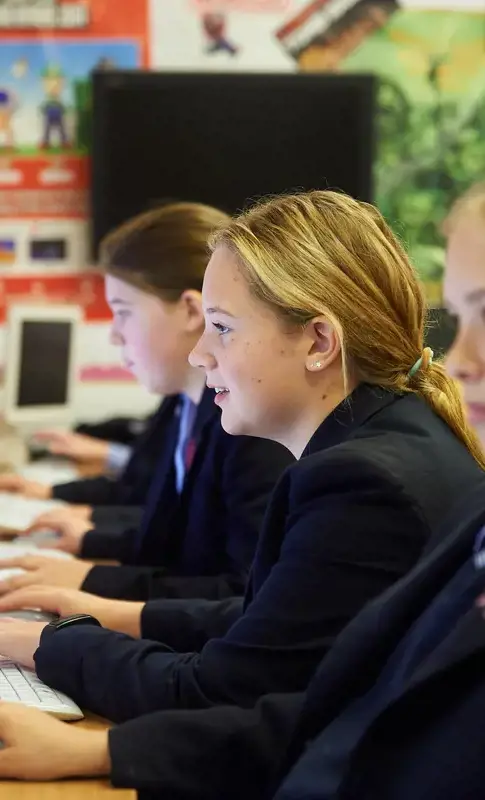 Senior school girls studying on computers